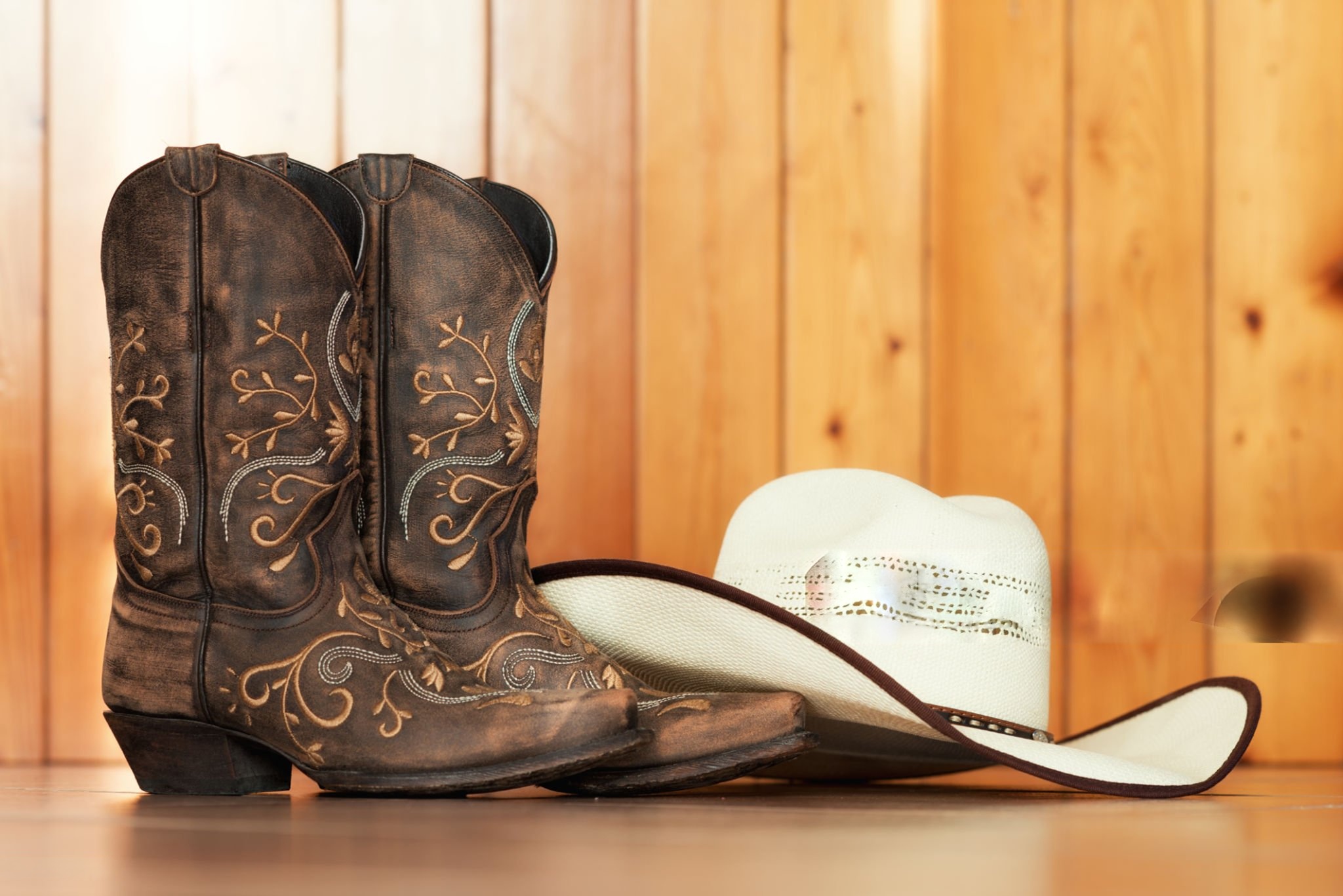 Western cowboy boots and hat representing Boot N Shoot franchise style.