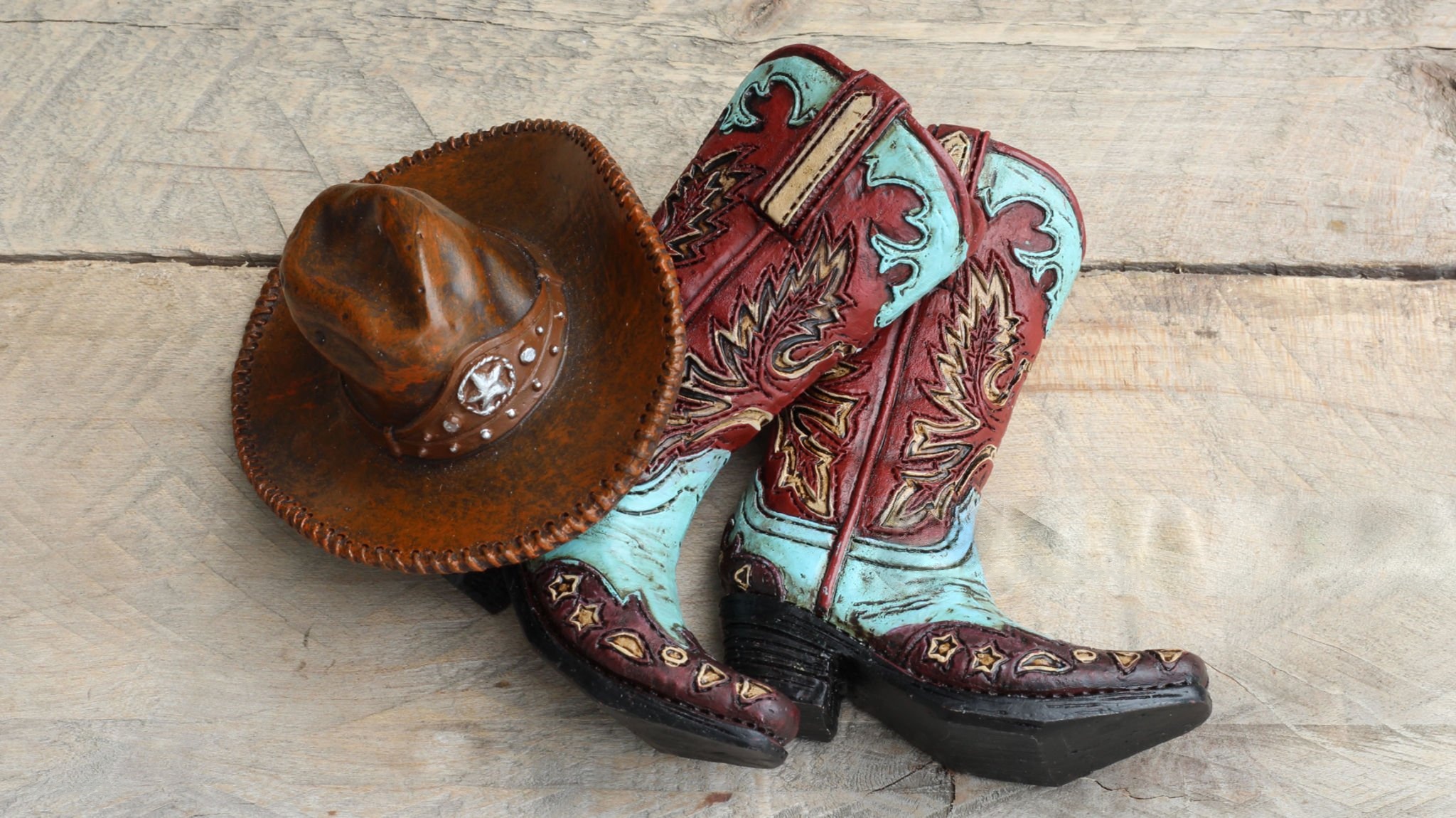 Feature image Western cowboy hat and colorful cowboy boots on wooden surface.