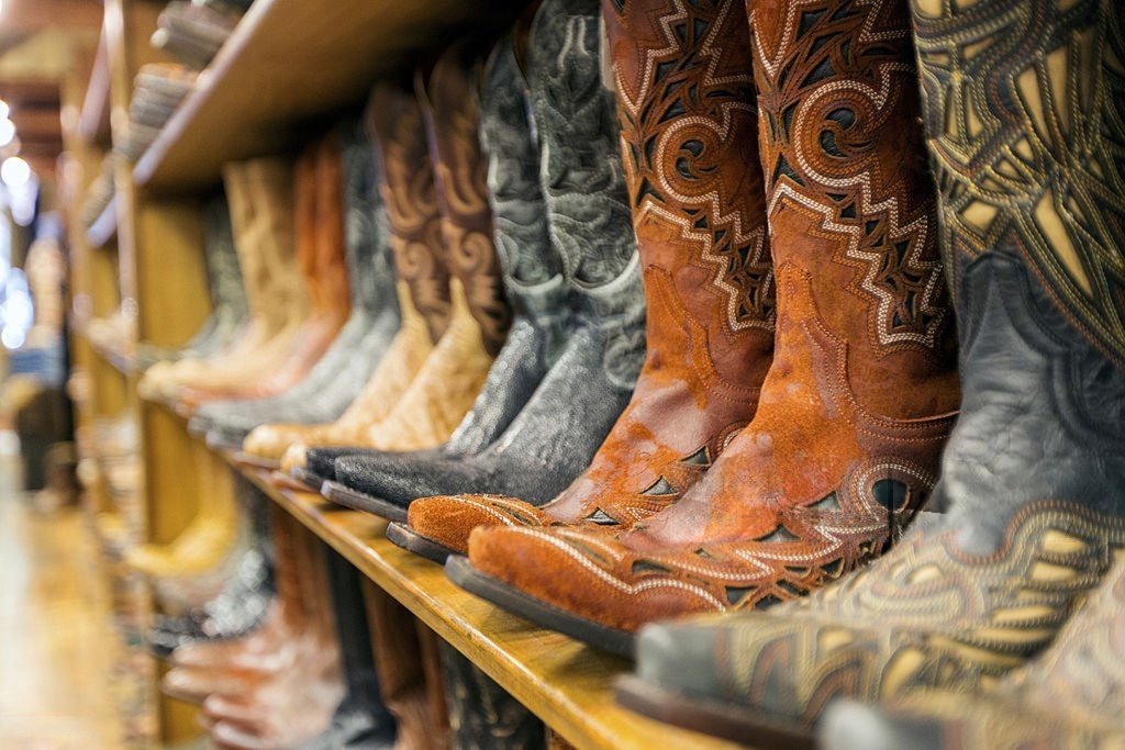 Feature image Western cowboy boots displayed on store shelves in a western wear shop.